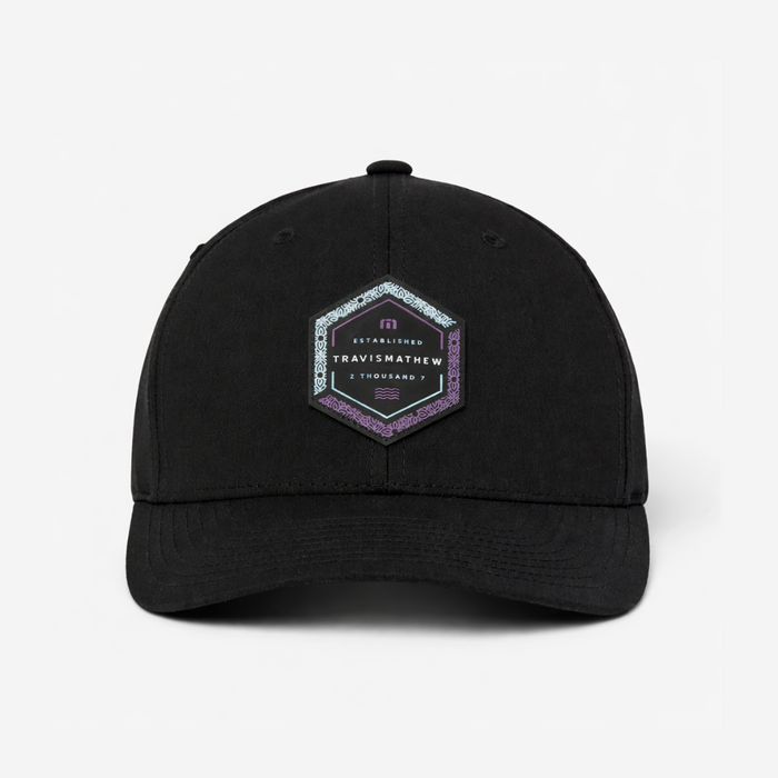 TravisMathew Word of Mouth snapback hat in black with hexagon logo patch, front view
