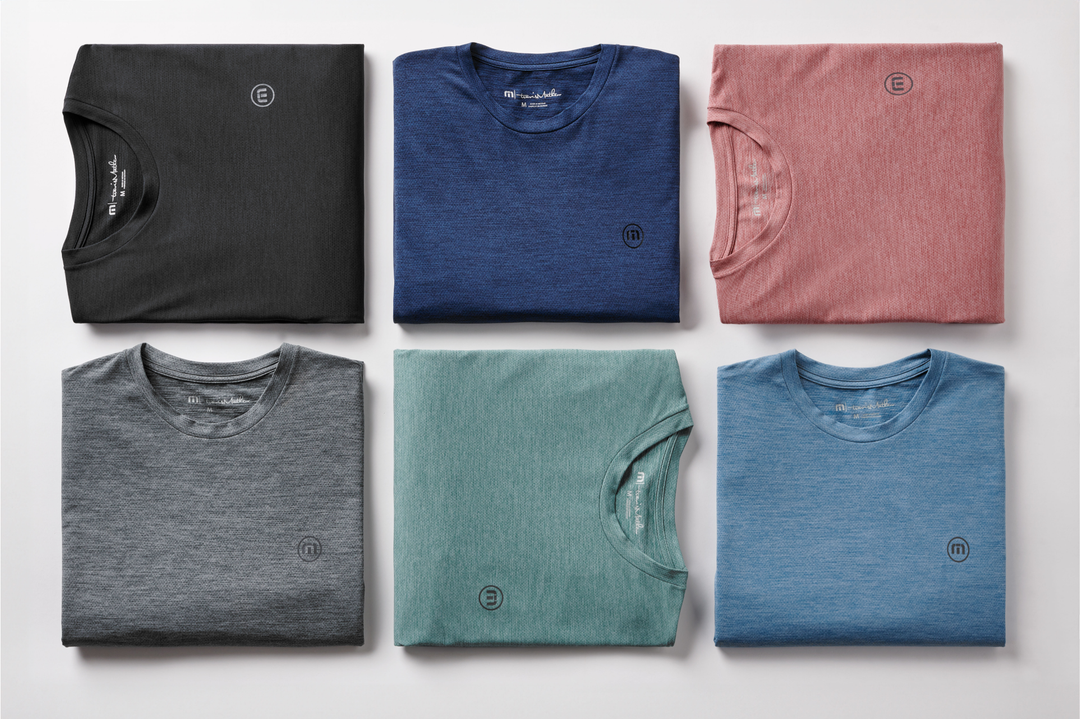 Assorted men’s short-sleeve t-shirts in neutral and muted colors, folded flat