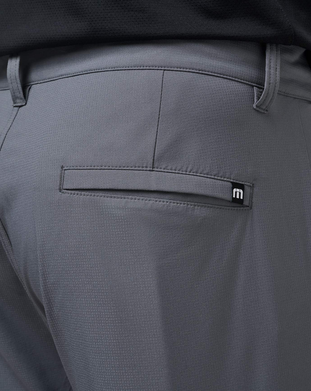 Detail shot of the Open to Close Jogger in grey showing the back pocket and logo.