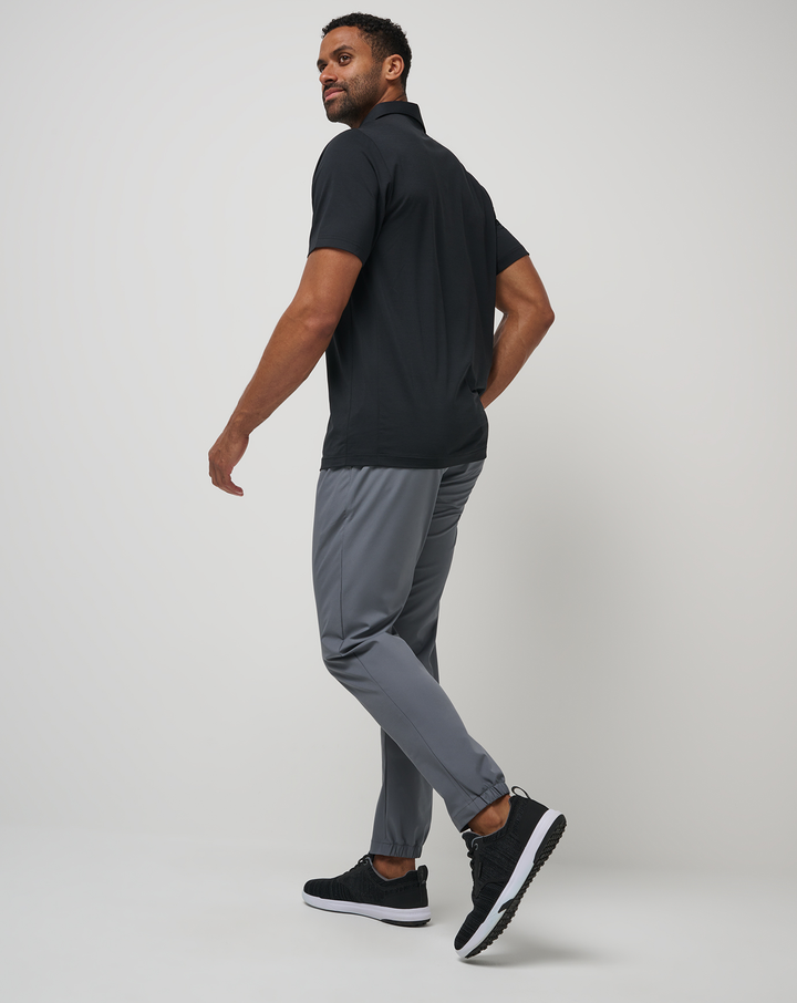 Lifestyle shot of a model wearing the Open to Close Jogger in grey.