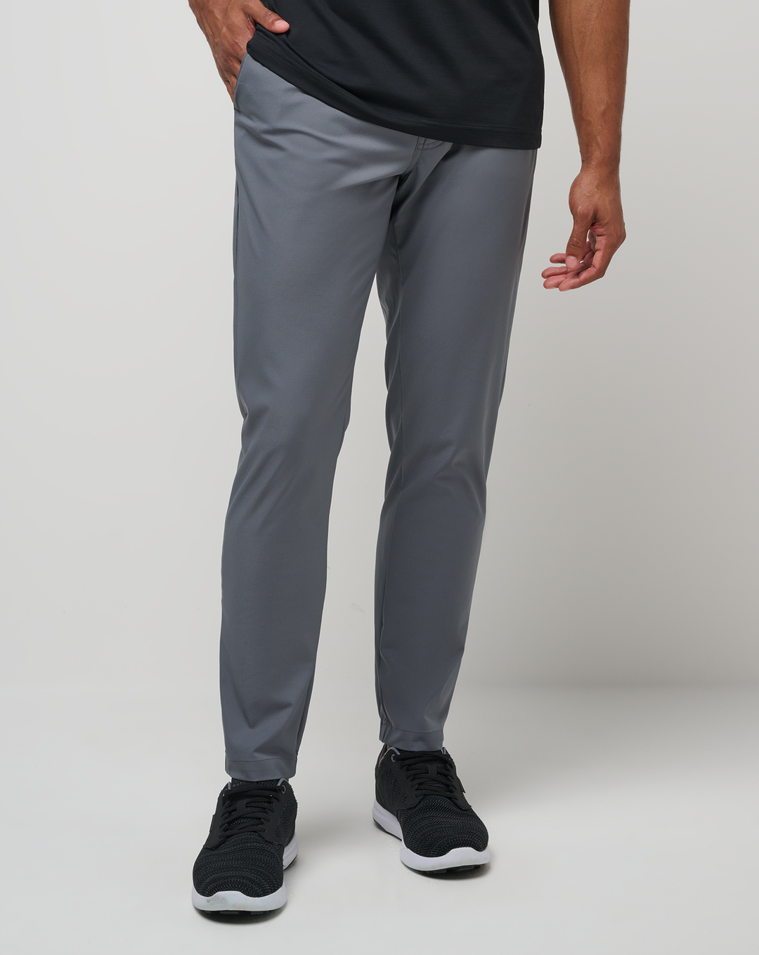 Model wearing the Open to Close Jogger in grey, featuring a tailored tapered fit and performance stretch fabric.