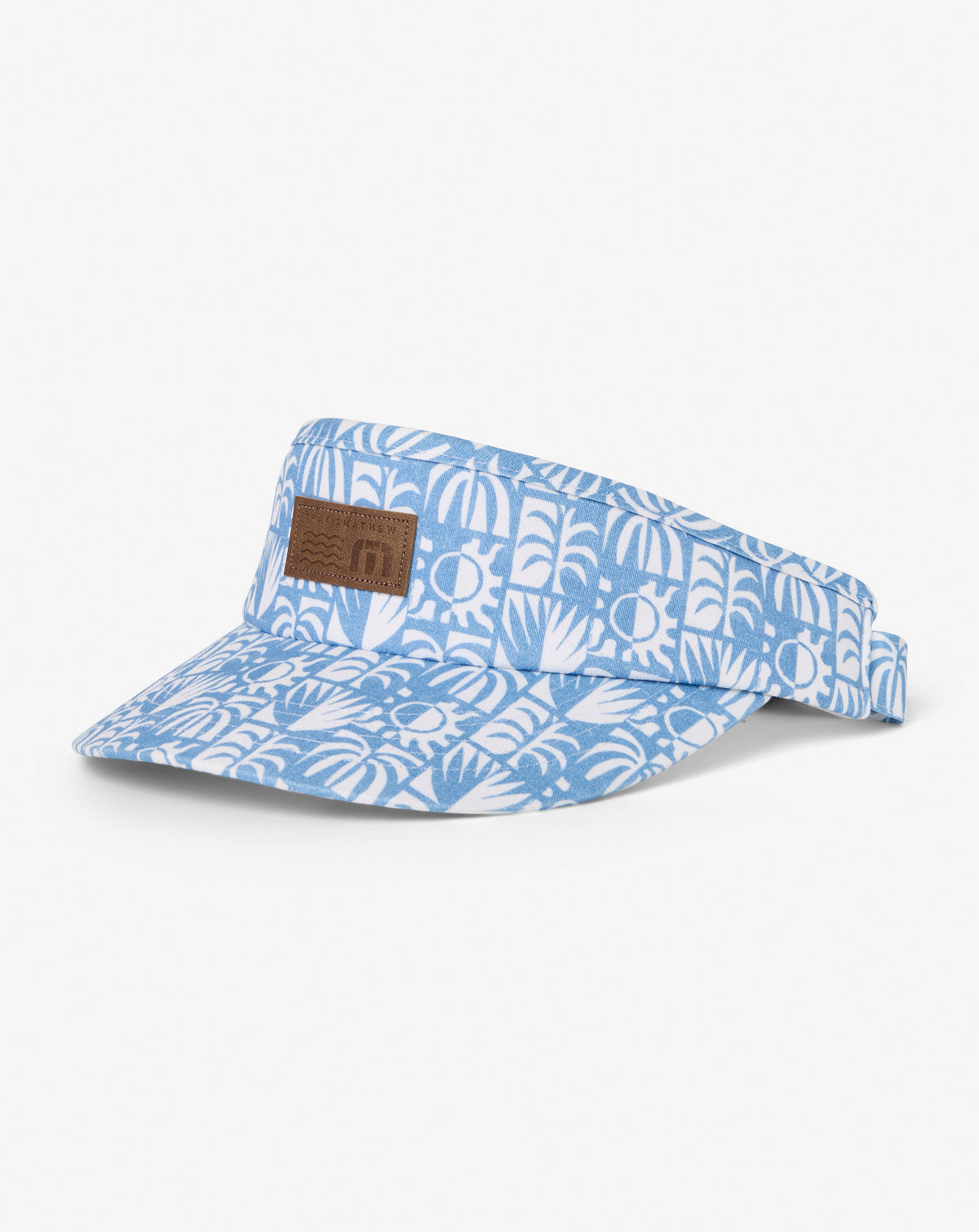 TravisMathew Crazy Weather Visor in blue patterned fabric with leather logo patch, side view.