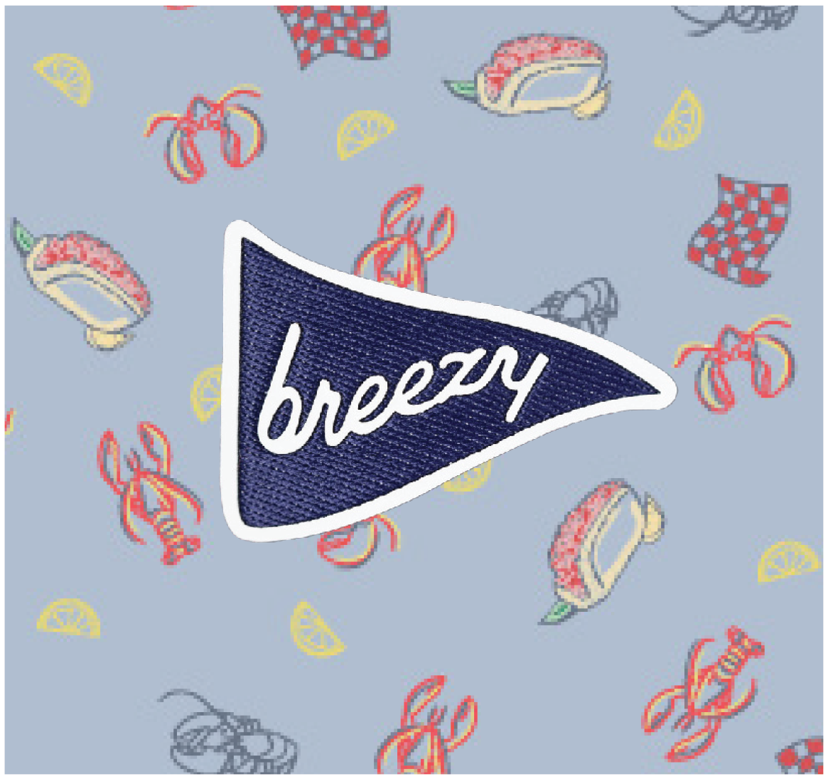 Close-up of lobster, lemon and roll print with Breezy logo patch.