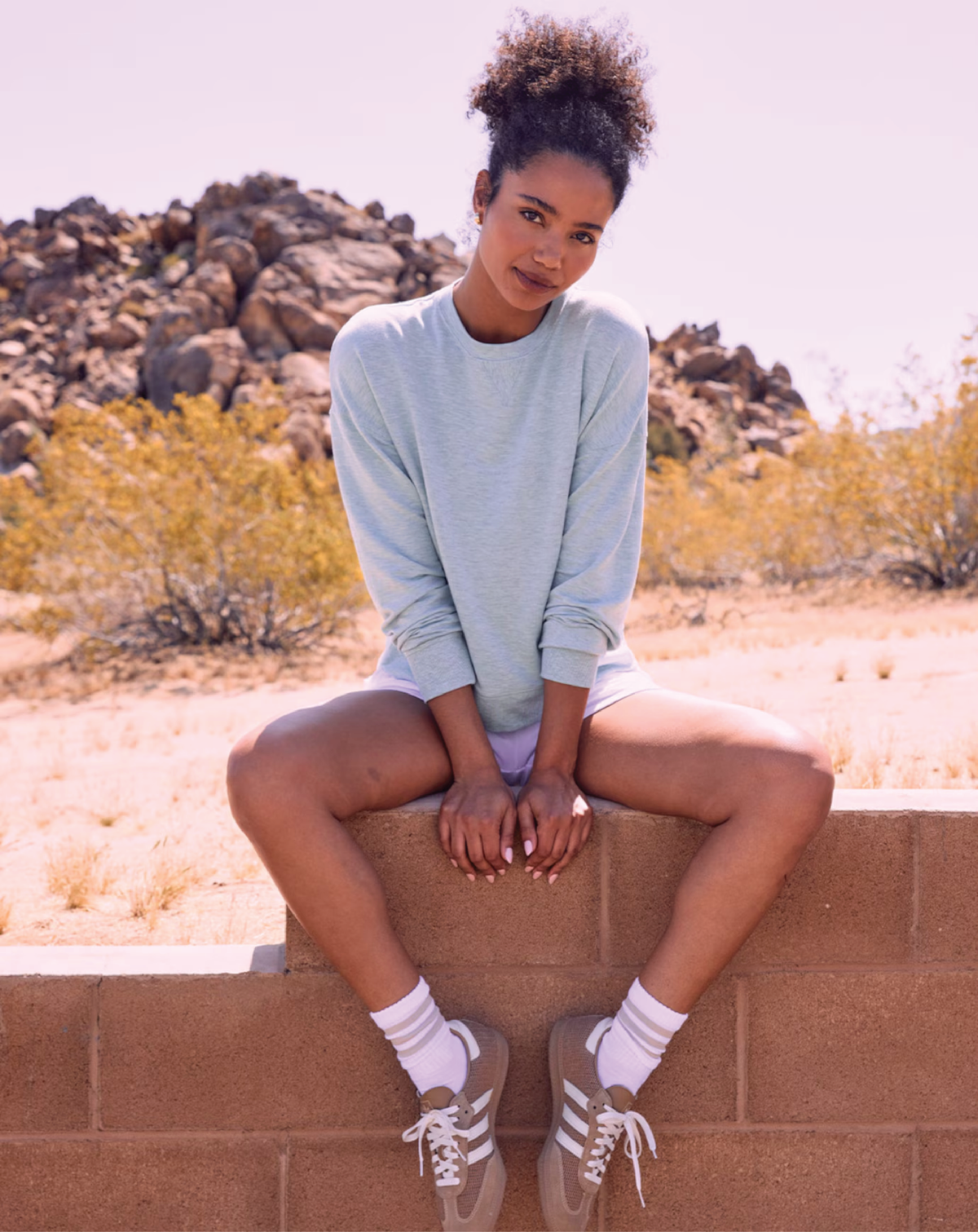 Lifestyle shot of a model wearing the TravisMathew Cloud Terry Crew outdoors.