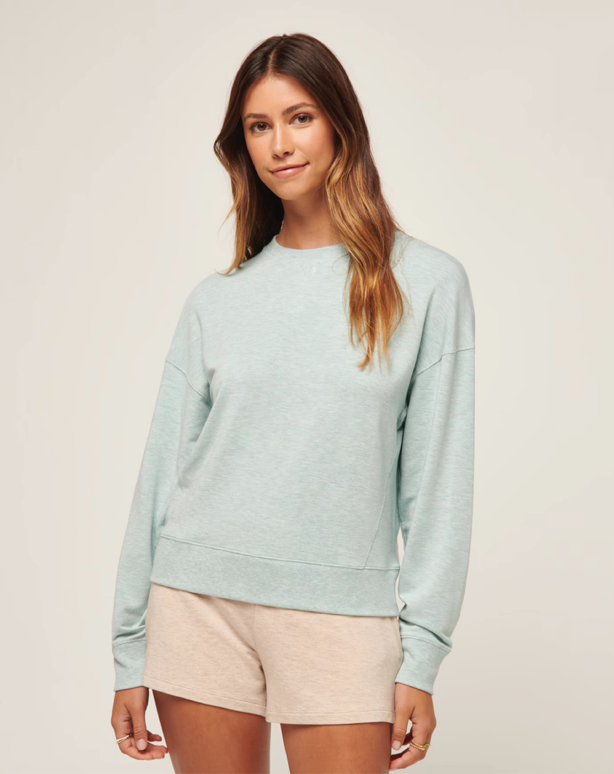 Model wearing the TravisMathew Cloud Terry Crew with a relaxed crewneck fit.