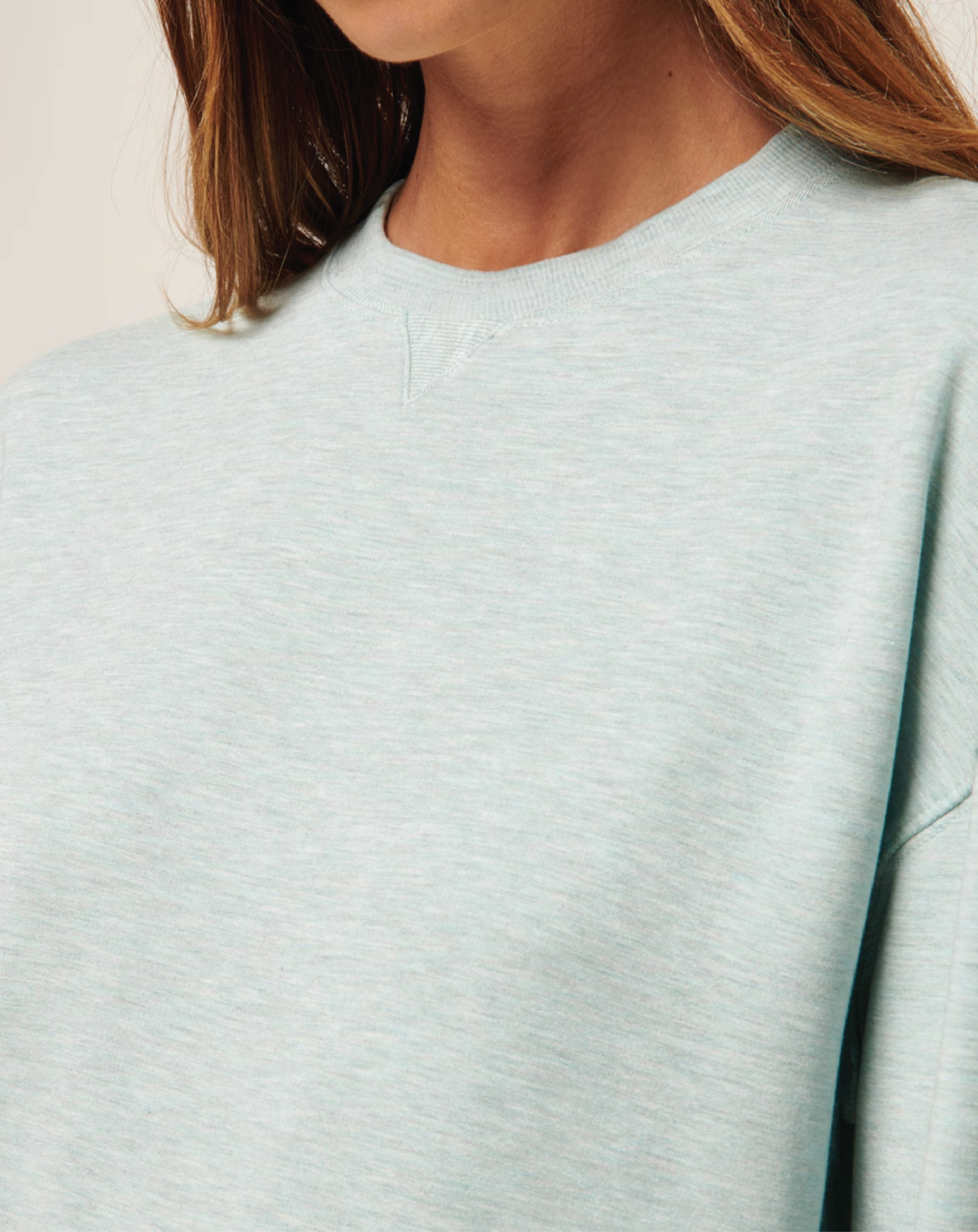 Detail shot of the TravisMathew Cloud Terry Crew showing the soft fabric and crewneck.