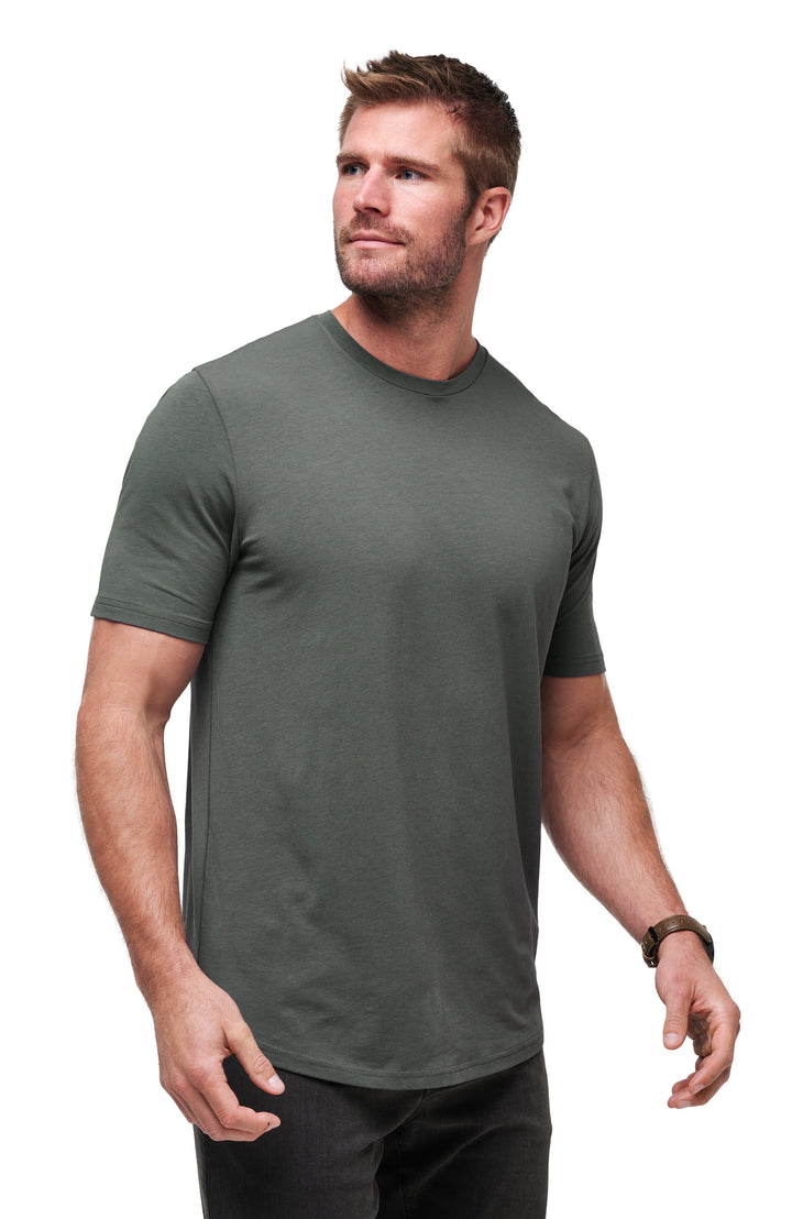 Male model wearing the TravisMathew Cloud Crew Tee in Dark Olive shown from a three-quarter angle 