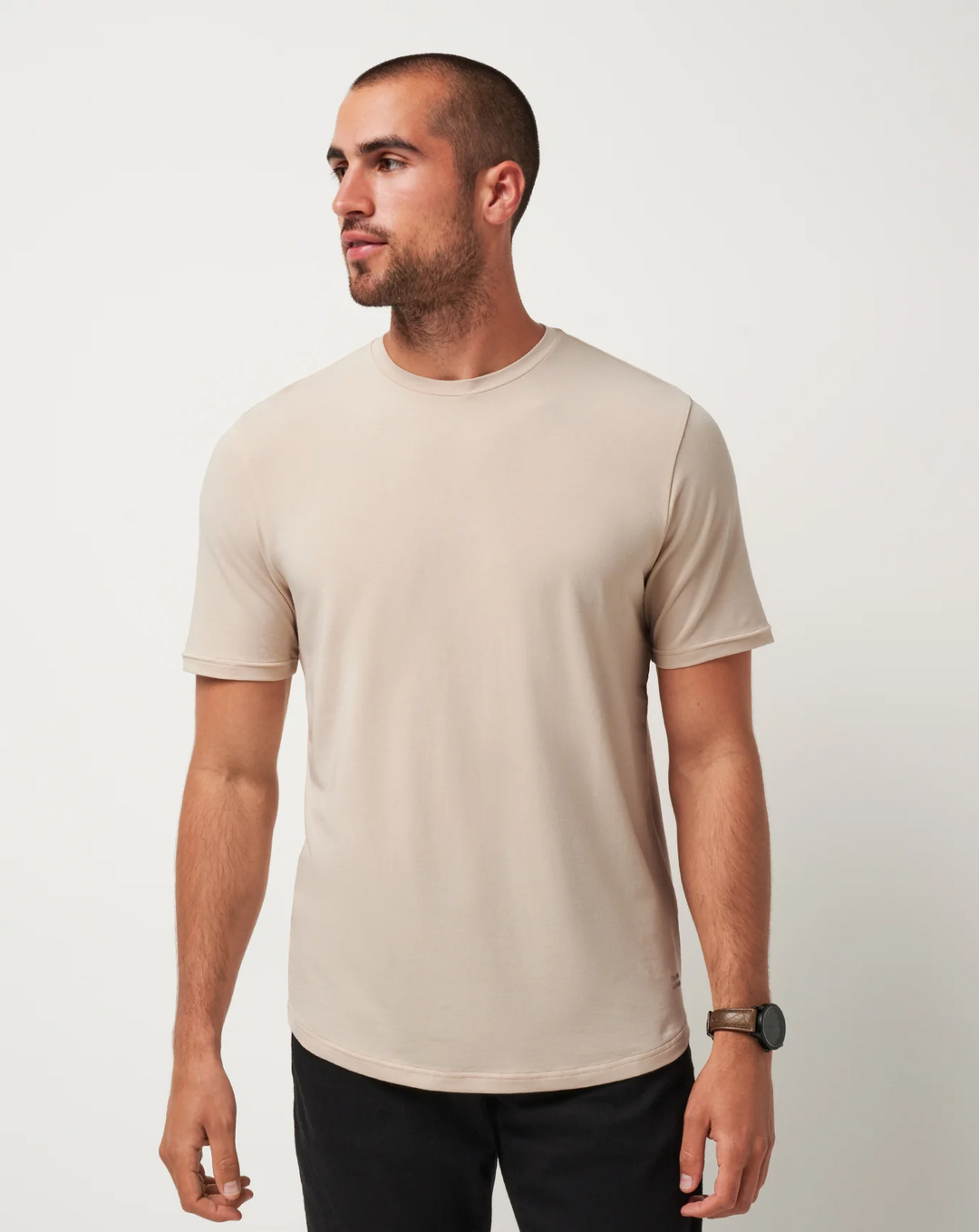 Front view of the TravisMathew Cloud Crew Tee in Italian Sand displaying the minimalist design 
