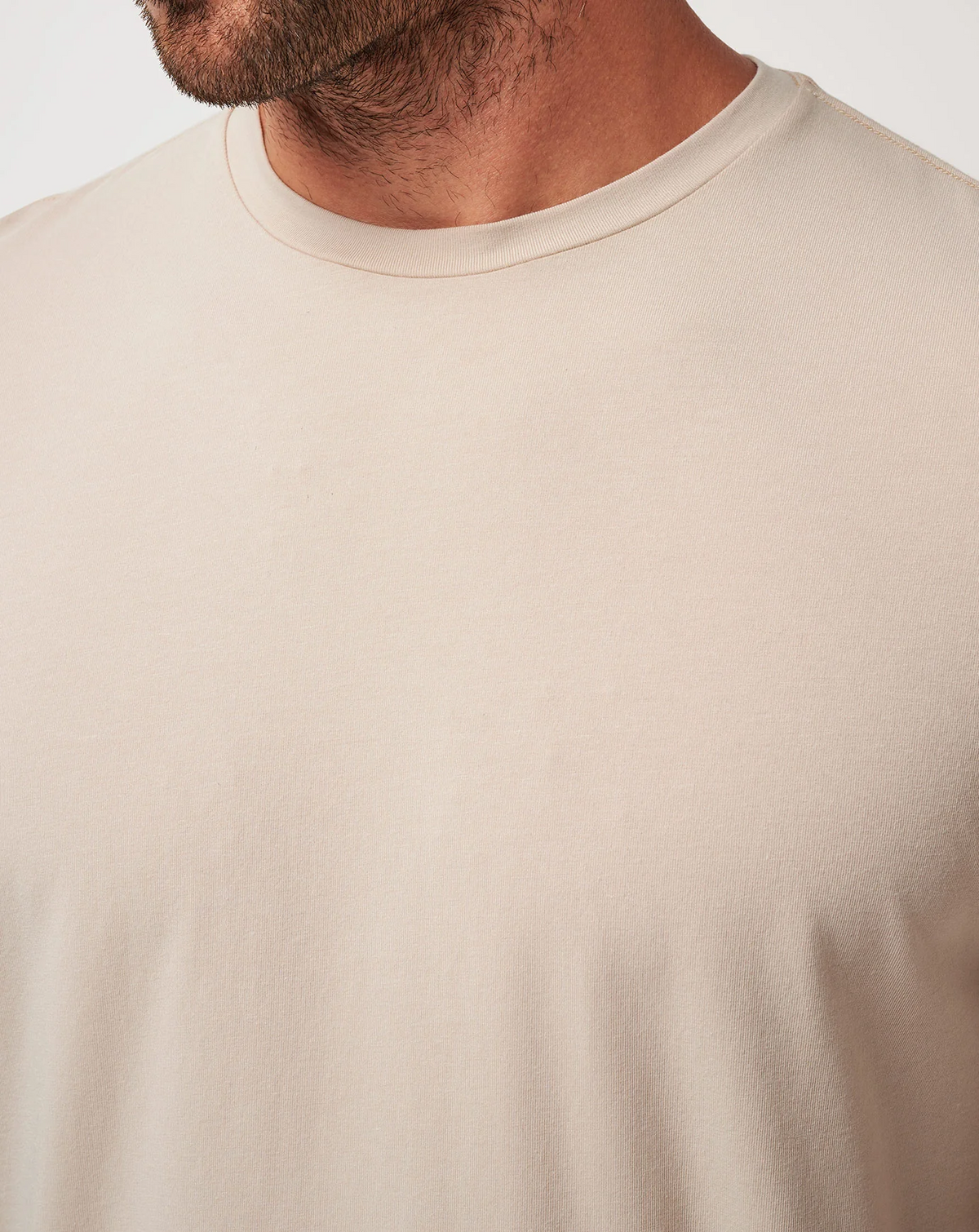 Close-up of the TravisMathew Cloud Crew Tee in Italian Sand highlighting the smooth fabric 