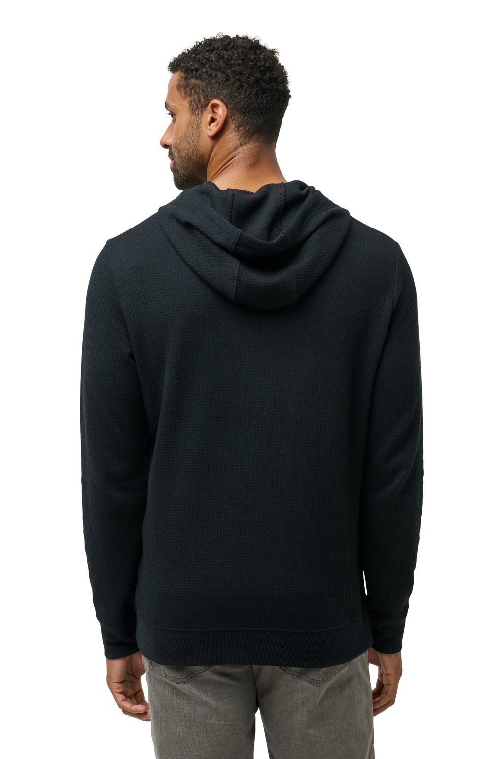 Men’s black hoodie worn from the side, highlighting relaxed silhouette and everyday fit