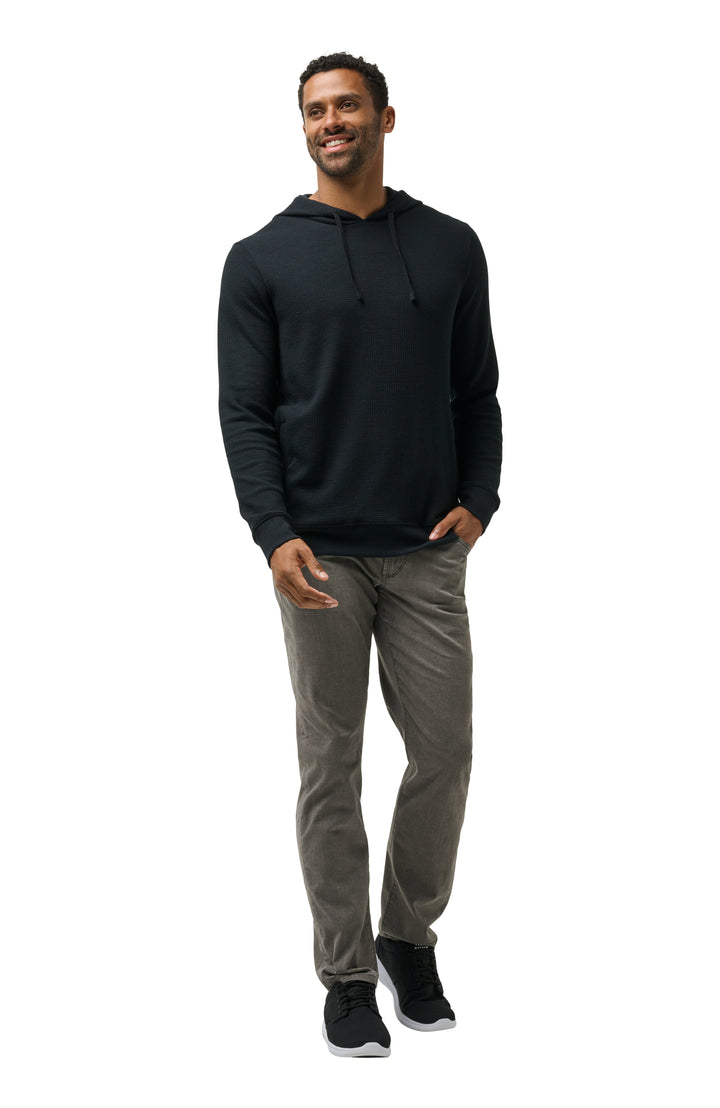 Men’s black hoodie styled head-to-toe with casual bottoms for an elevated off-course look