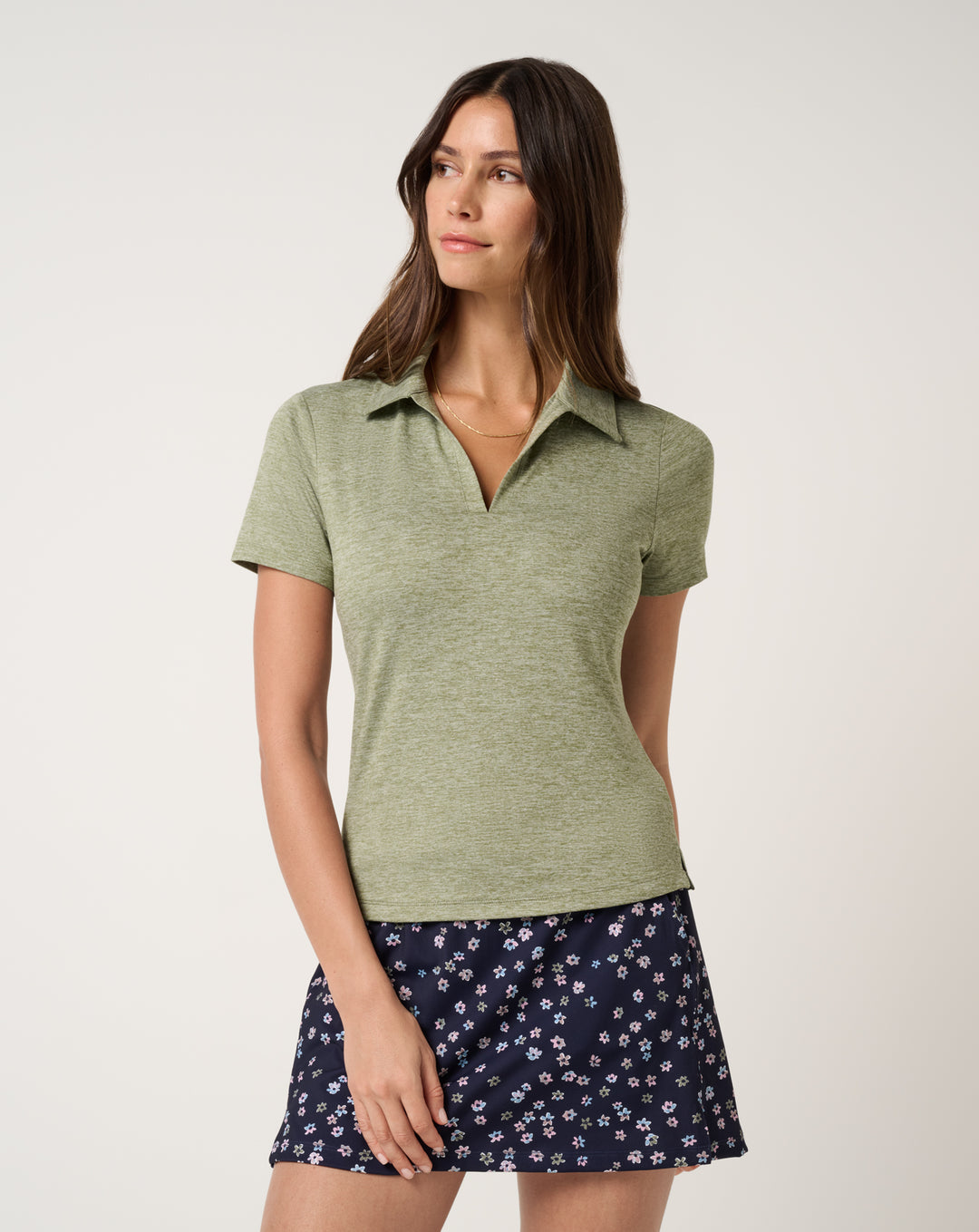 TravisMathew women’s Skyloft Light Polo in heather oil green with fitted golf styling.