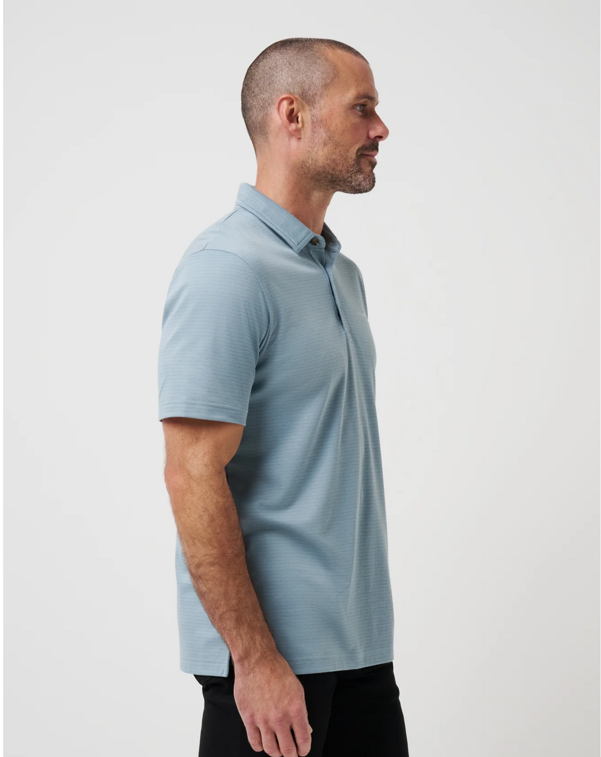Side view of Zinna 2.0 polo in light blue showing lightweight fabric and stretch