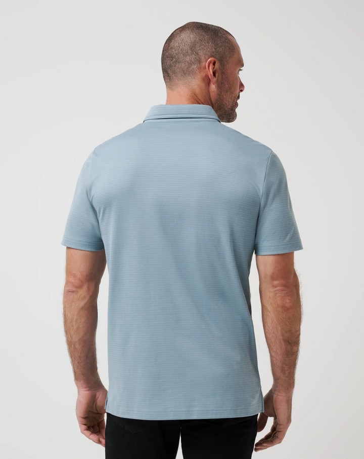 Back view of Zinna 2.0 performance polo in light blue with smooth, breathable fabric