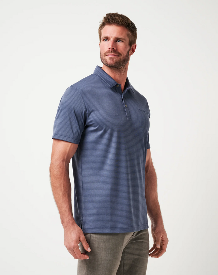 Three-quarter view of model wearing Zinna 2.0 polo in vintage indigo with clean drape