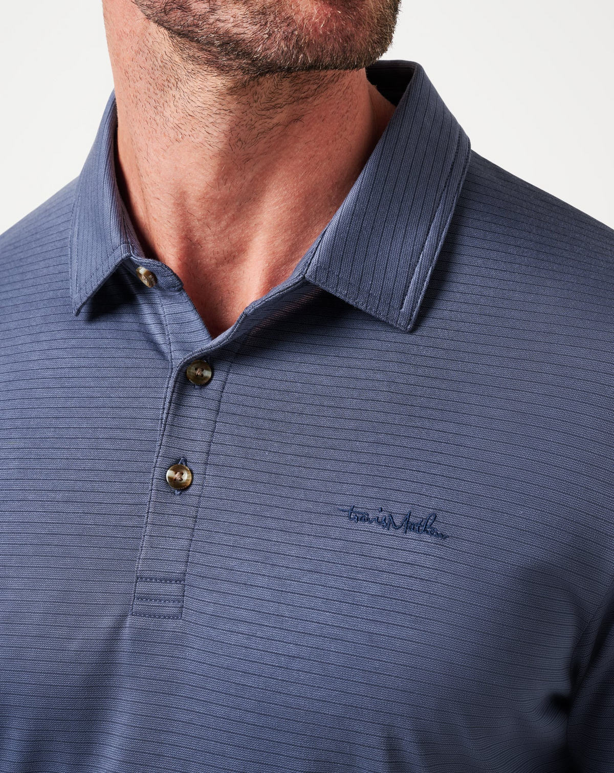 Close-up of Zinna 2.0 polo collar and fabric texture in indigo blue colourway