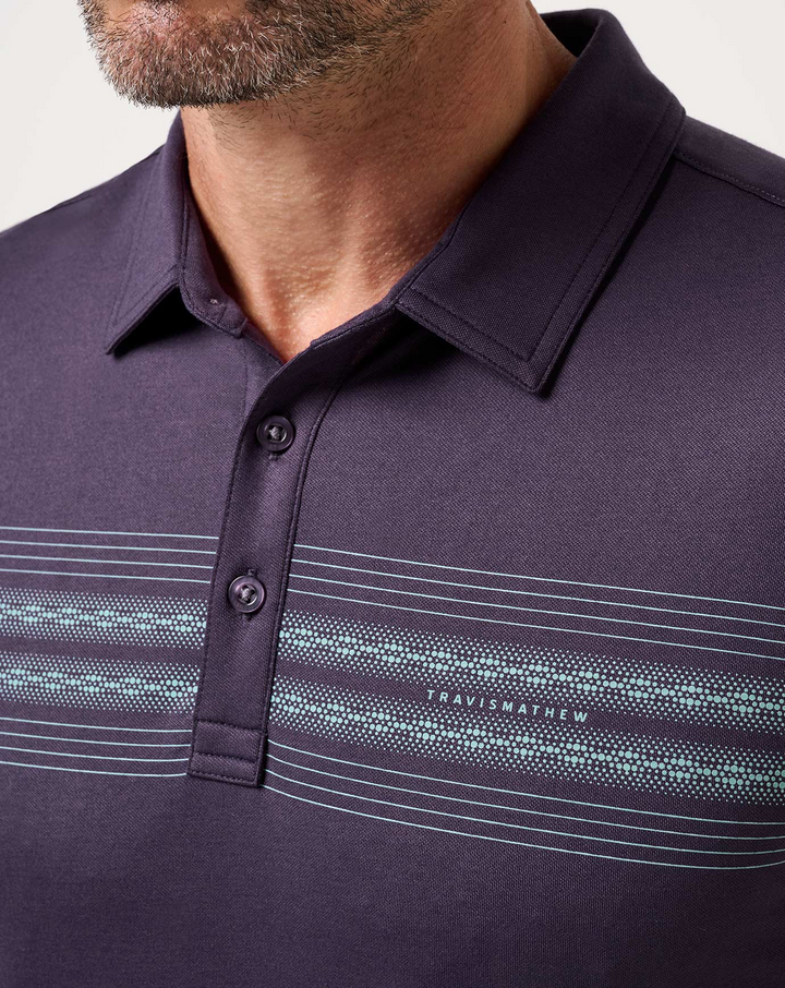 Close-up of TravisMathew featherweight chest stripe polo highlighting collar construction, button placket, and horizontal stripe graphic