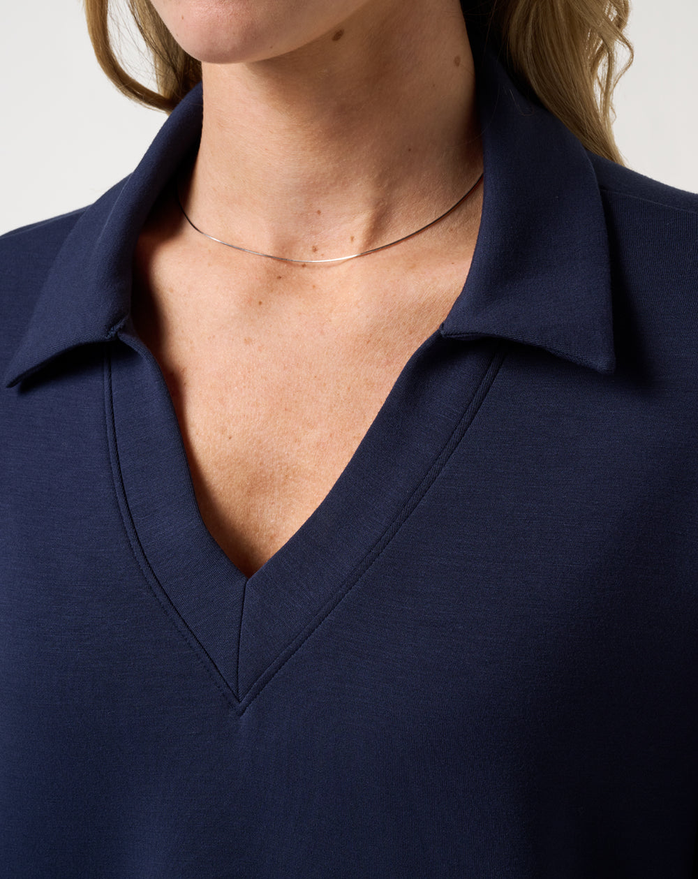 TravisMathew Women's Skyloft Soft V-Neck Pullover navy close-up of V-neck collar detail