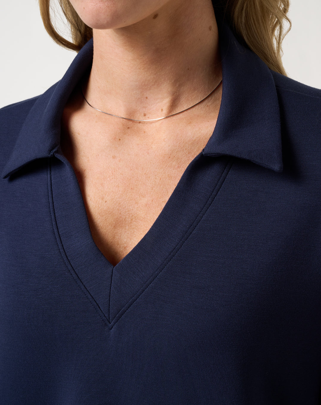 TravisMathew Women's Skyloft Soft V-Neck Pullover navy close-up of V-neck collar detail
