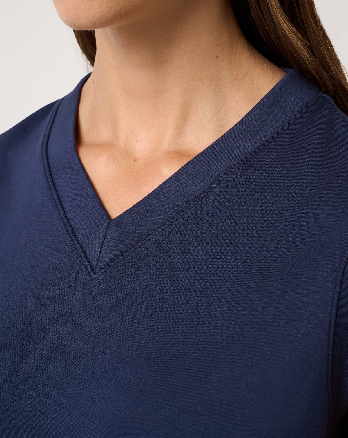 Close-up of TravisMathew women’s Skyloft Soft Vest V-neck detail in navy.
