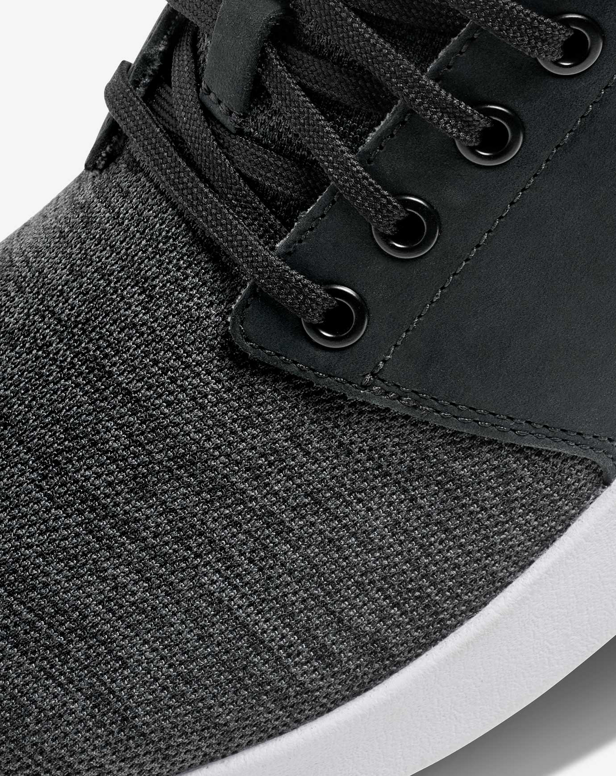 Close-up of TravisMathew Daily 3 knit upper and lace eyelets with leather overlay