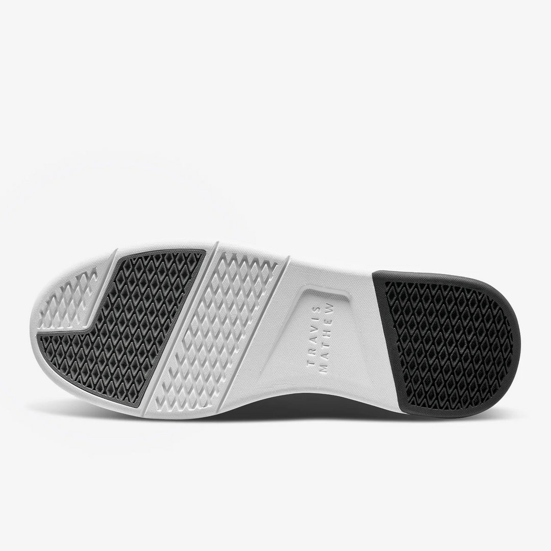 Bottom view of TravisMathew Daily 3 shoe outsole with rubber traction zones