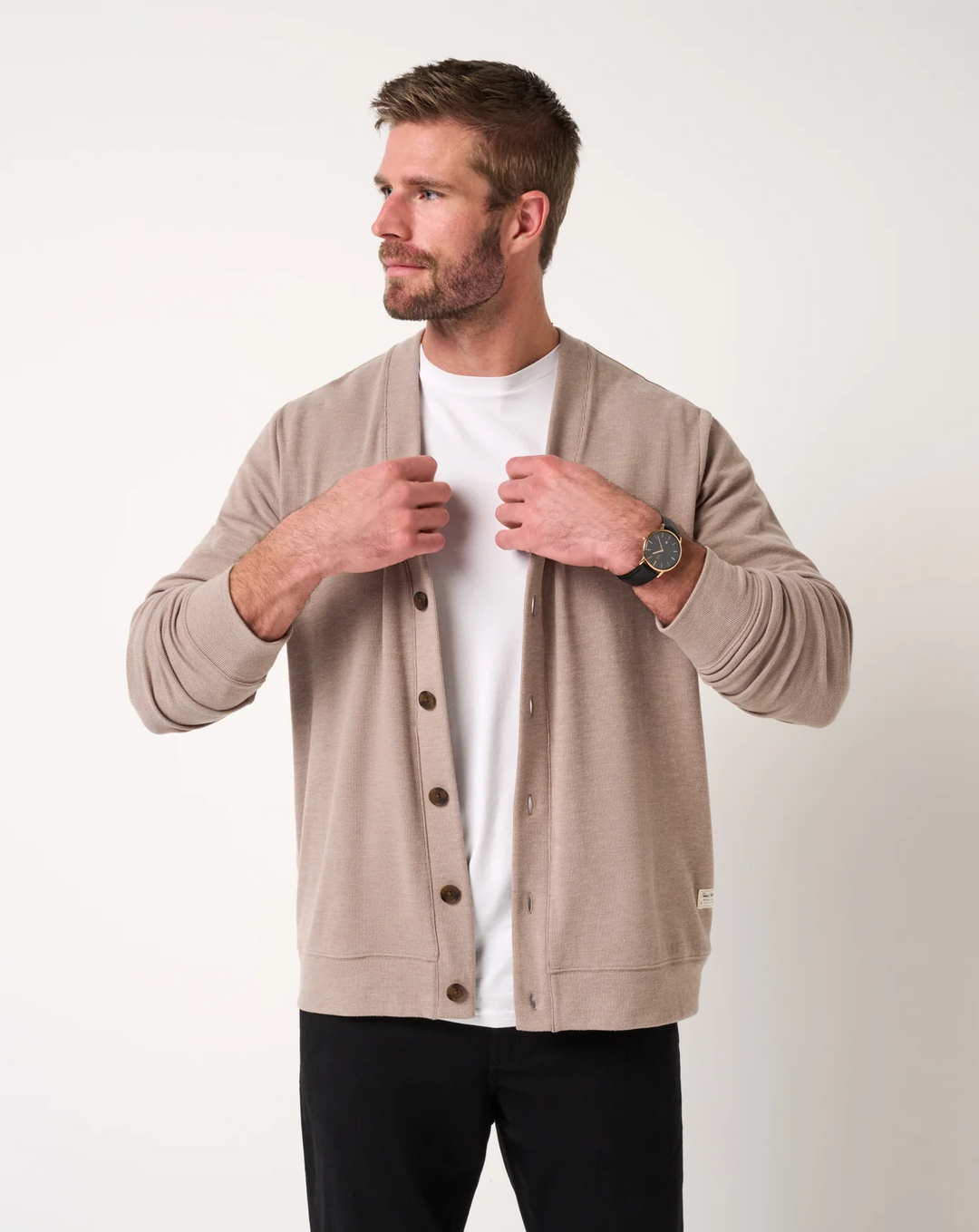 Front view of men’s heather beige cardigan sweater with V-neck opening and button front, worn over a white t-shirt