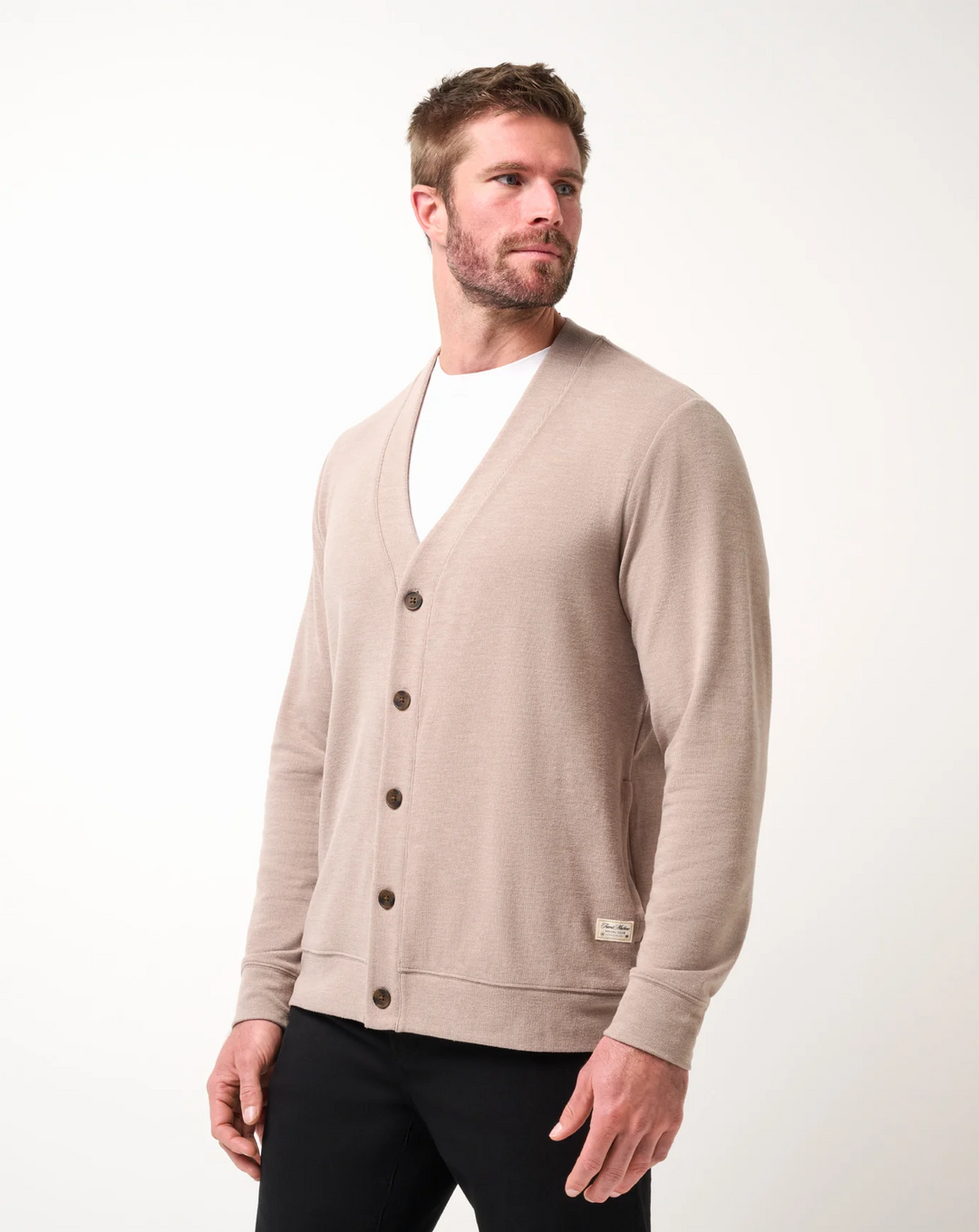 Angled front view of men’s heather beige V-neck cardigan sweater with button closure and soft drape