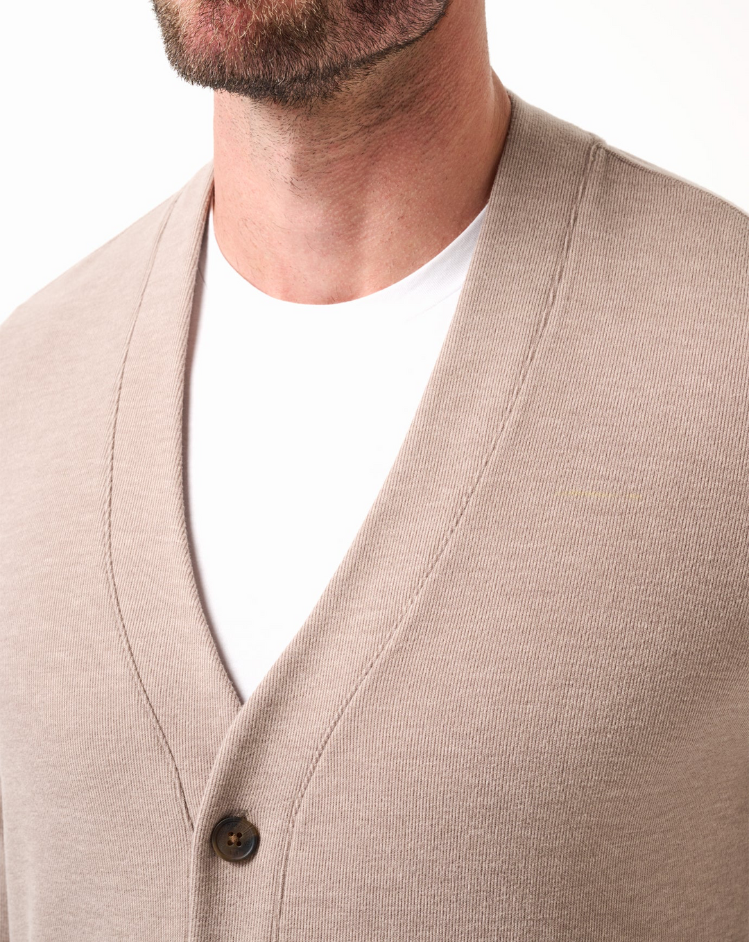 Close-up of V-neck neckline and button detail on heather beige cardigan sweater