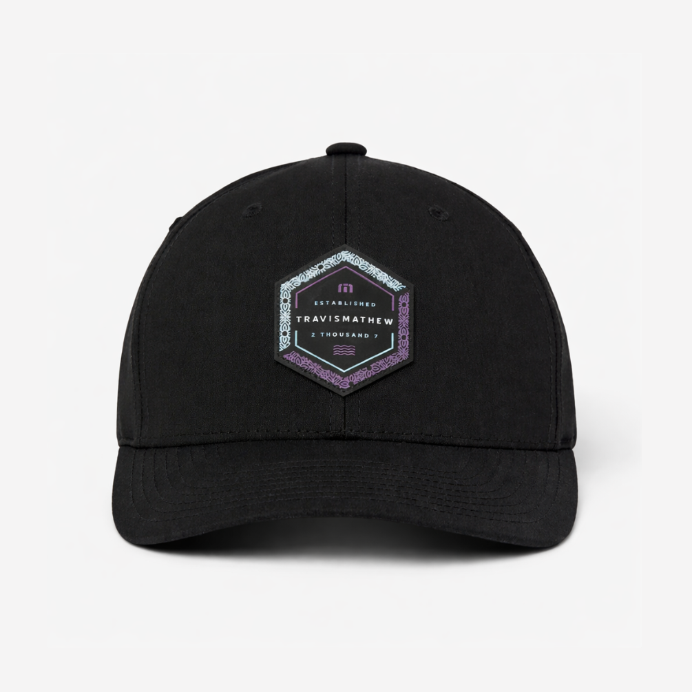 TravisMathew Word of Mouth snapback hat in black with hexagon logo patch, front view