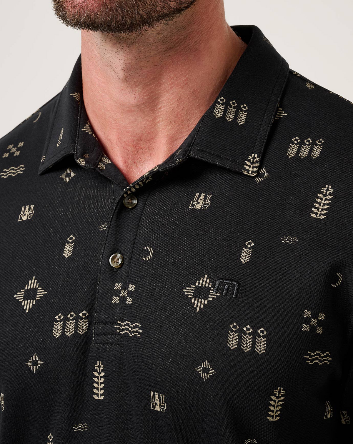 Close-up of black Weather Patterns Polo collar and jacquard fabric details