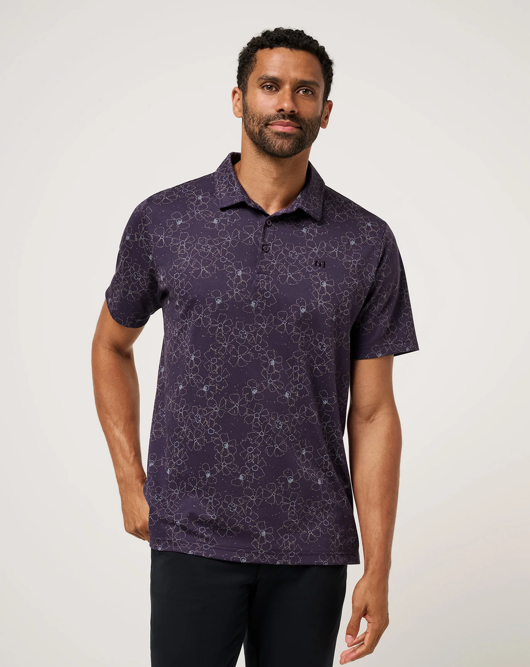 Men’s TravisMathew Just My Type Polo in deep purple with subtle floral line print, front view