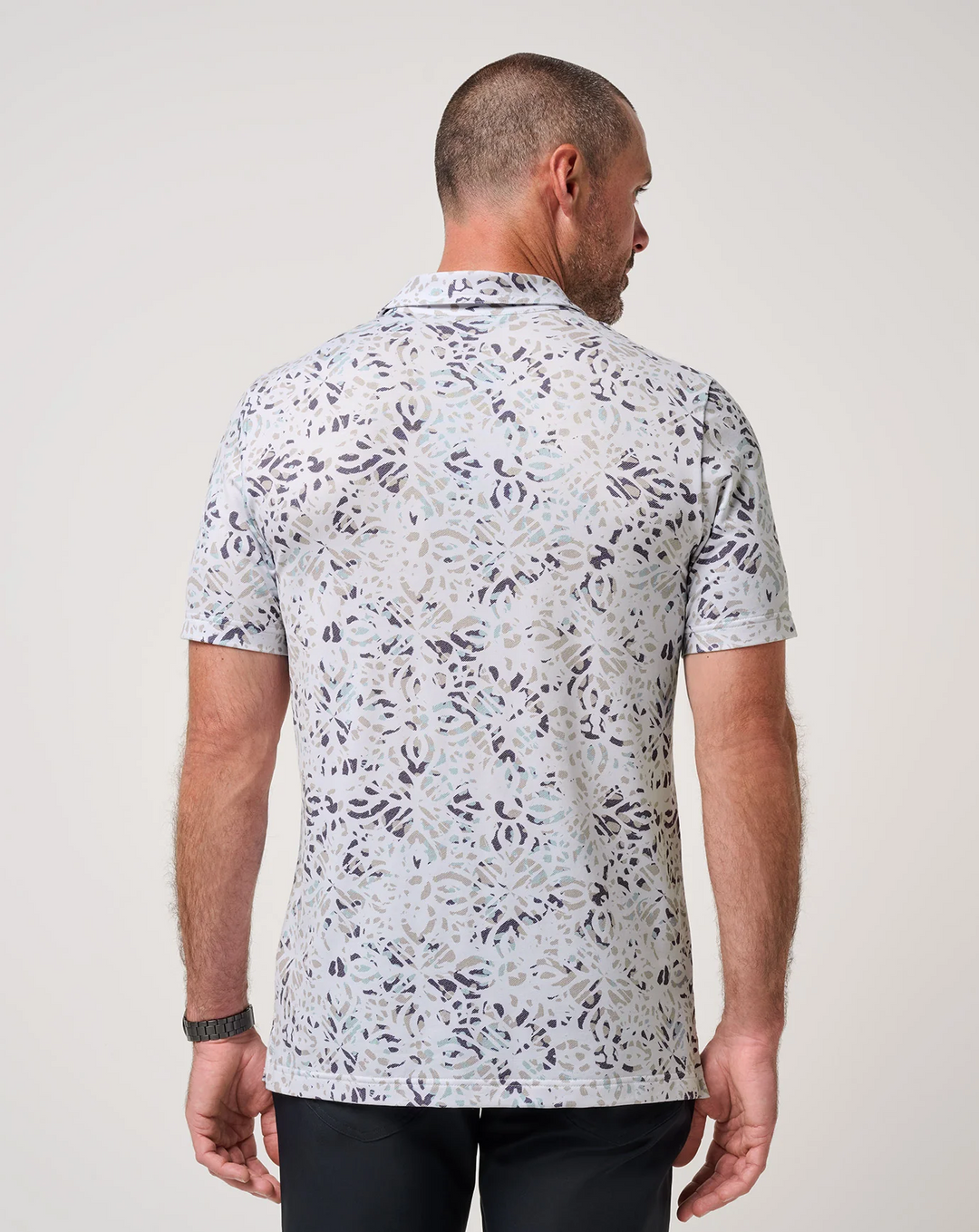 Back view of TravisMathew Featherweight Chill Polo with abstract print