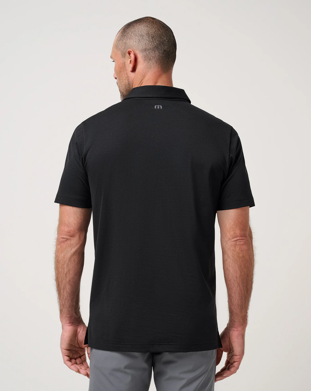 Back view of the TravisMathew Performance Jersey Flight Polo in black 