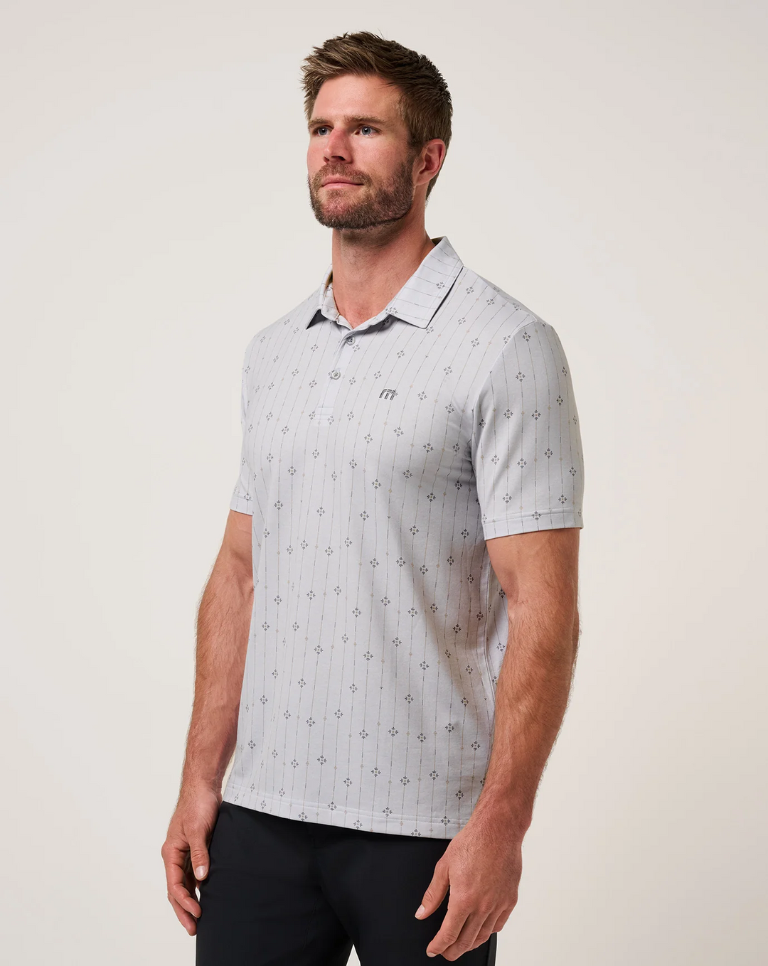 TravisMathew Featherweight Deco Polo  shown from angled front view