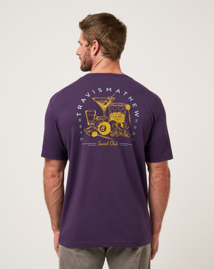 Back view of TravisMathew Social Hour T-Shirt in purple with graphic print