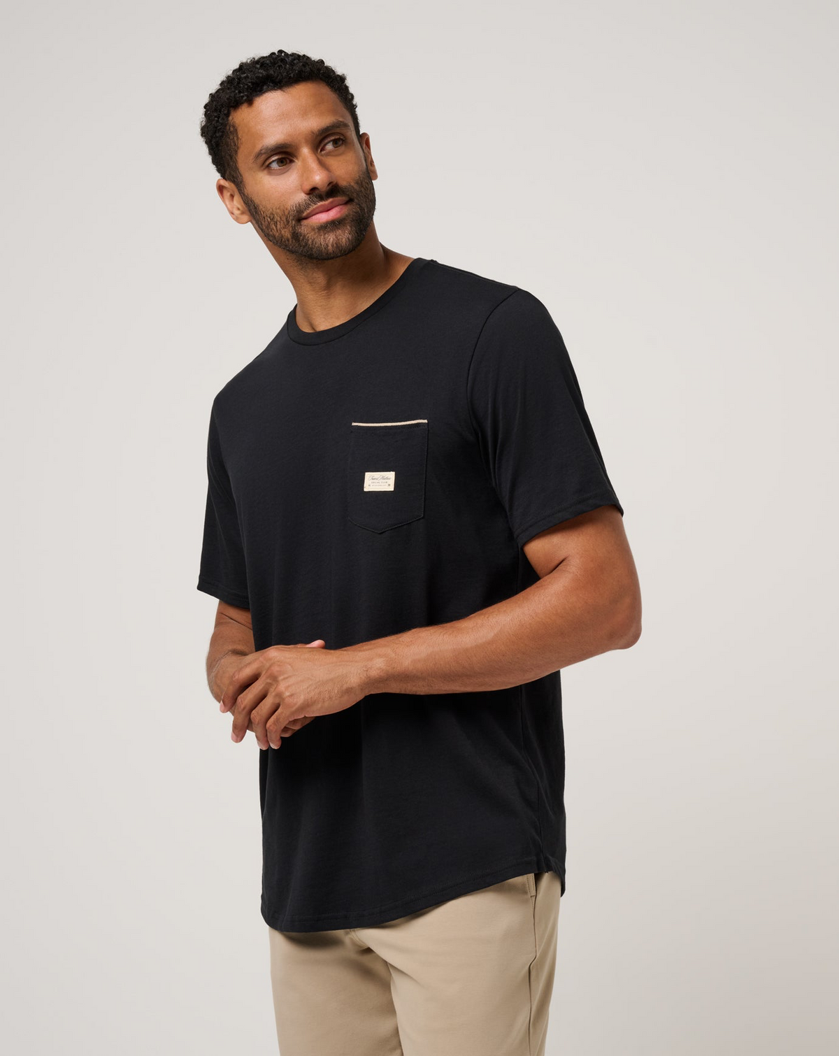 Angled front view of TravisMathew Social Club Tee in black