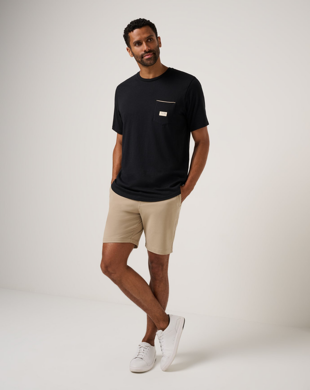 Full-body front view of TravisMathew Social Club Tee in black