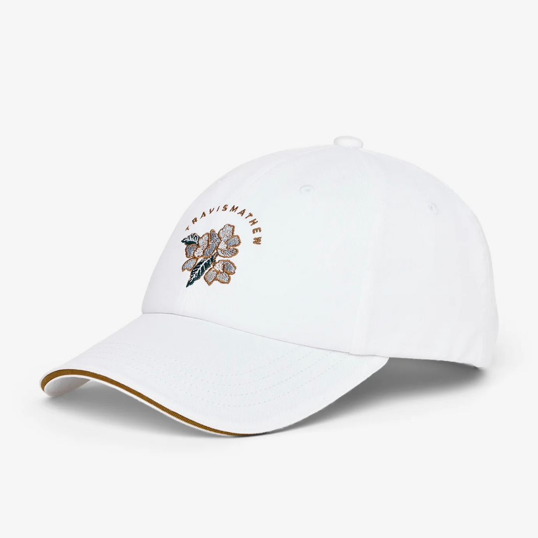 White floral TravisMathew baseball cap with subtle embroidery detail