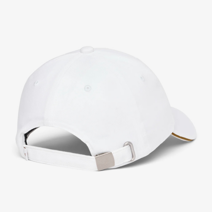 Back of white TravisMathew cap with adjustable strap closure