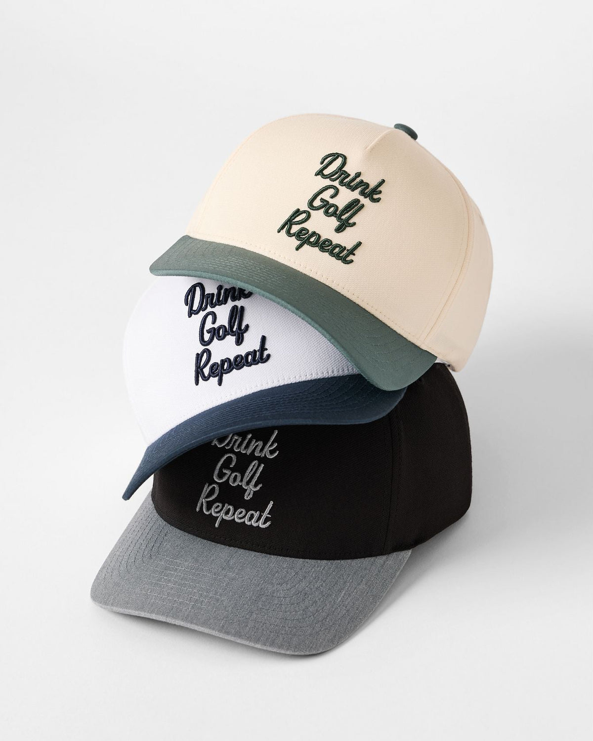 TravisMathew Swing & Sip golf hats in multiple colourways featuring embroidered Drink Golf Repeat design and premium snapback construction.