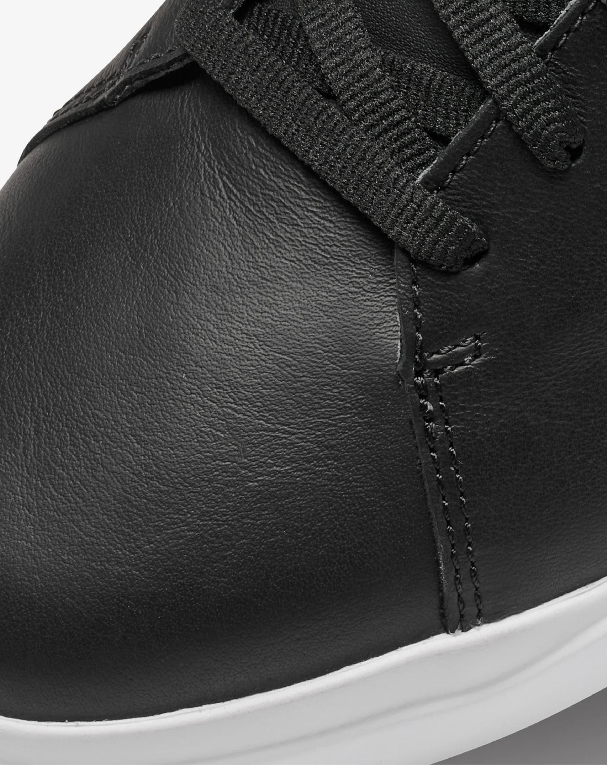 Detail view of the black leather upper on the TravisMathew Modern Cup Shoe.