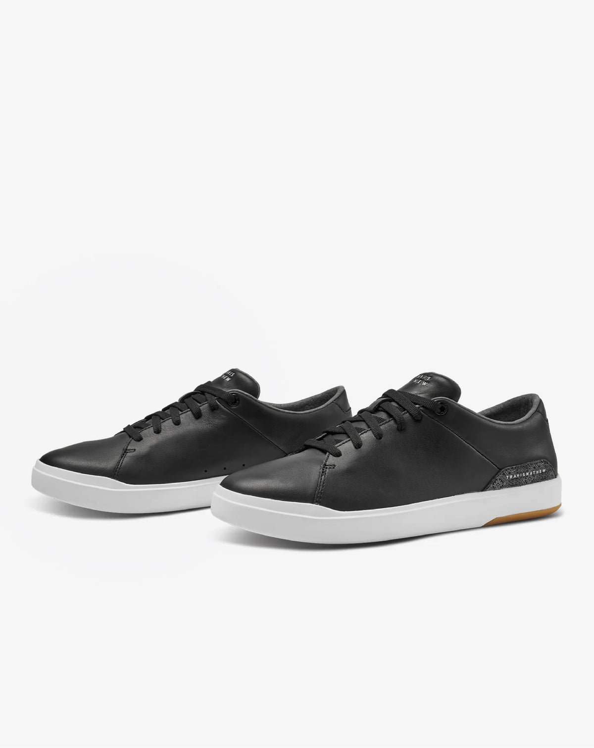 Black leather TravisMathew Modern Cup Shoes with white soles.