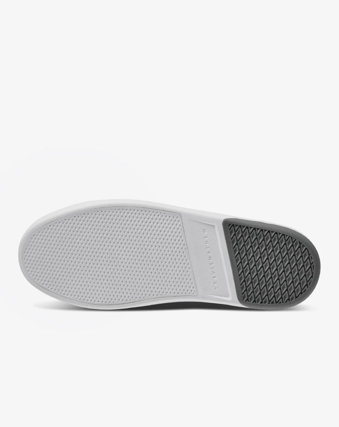 Bottom view of TravisMathew Modern Cup Shoe showing white midsole and textured rubber outsole.