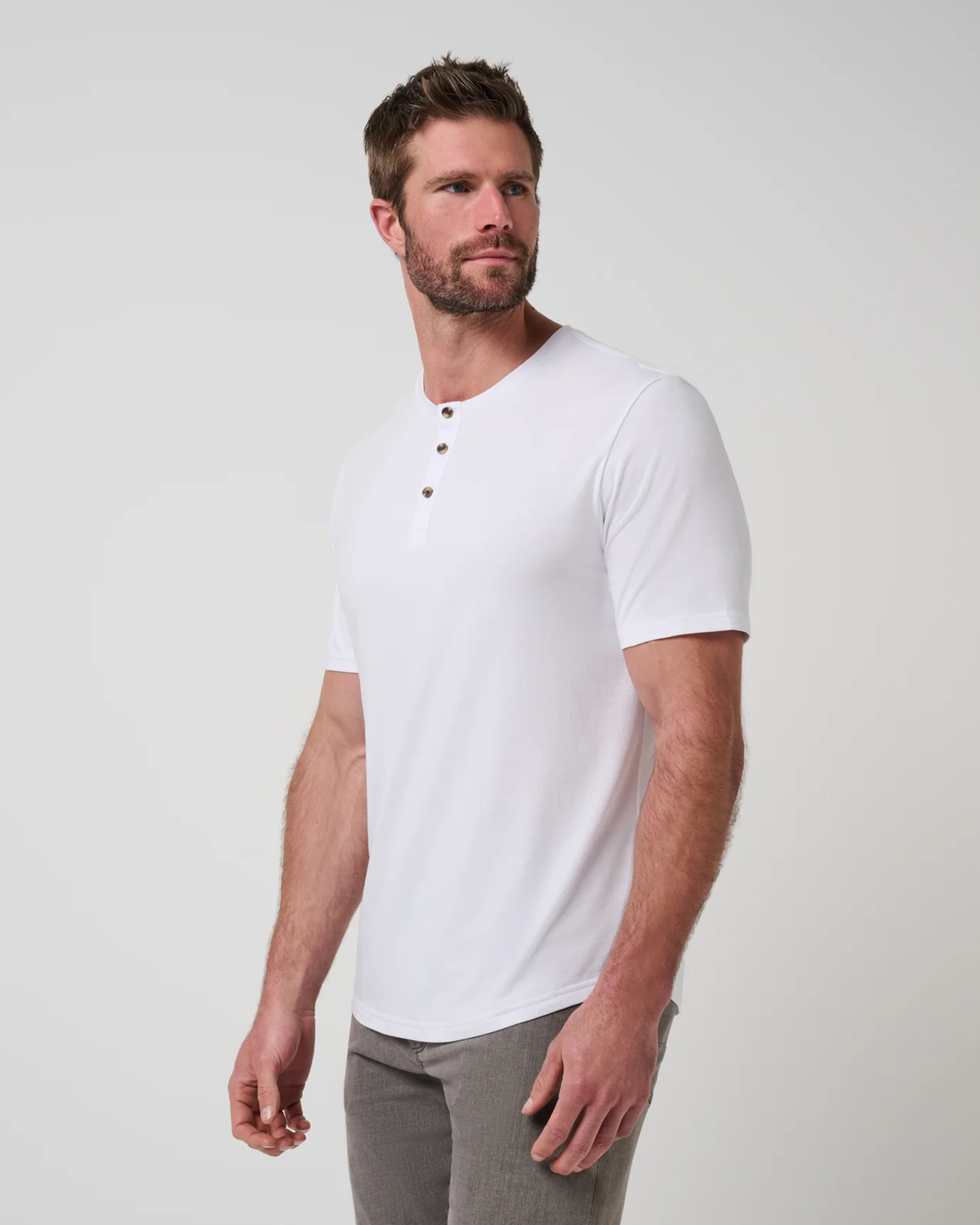 TravisMathew Cloud Henley Tee in white, side view on model