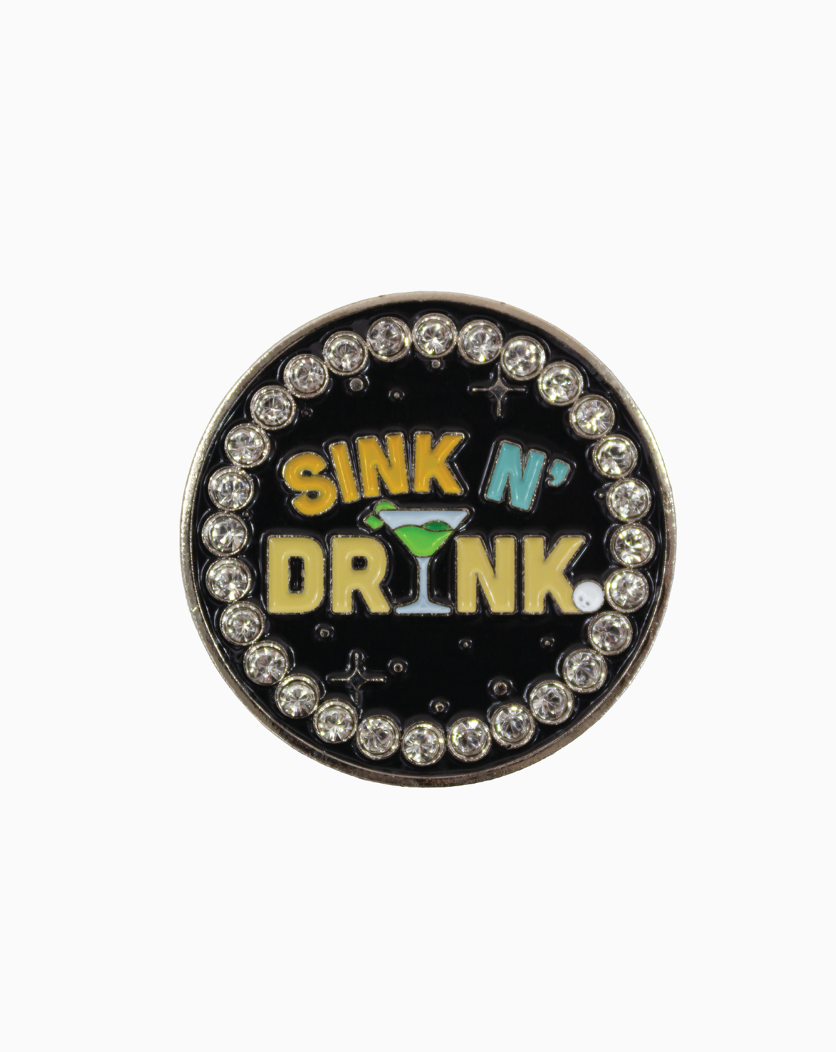 A round MXM ball marker featuring the phrase “Sink N’ Drink” with a green martini glass design on a black enamel background, surrounded by sparkling crystals.